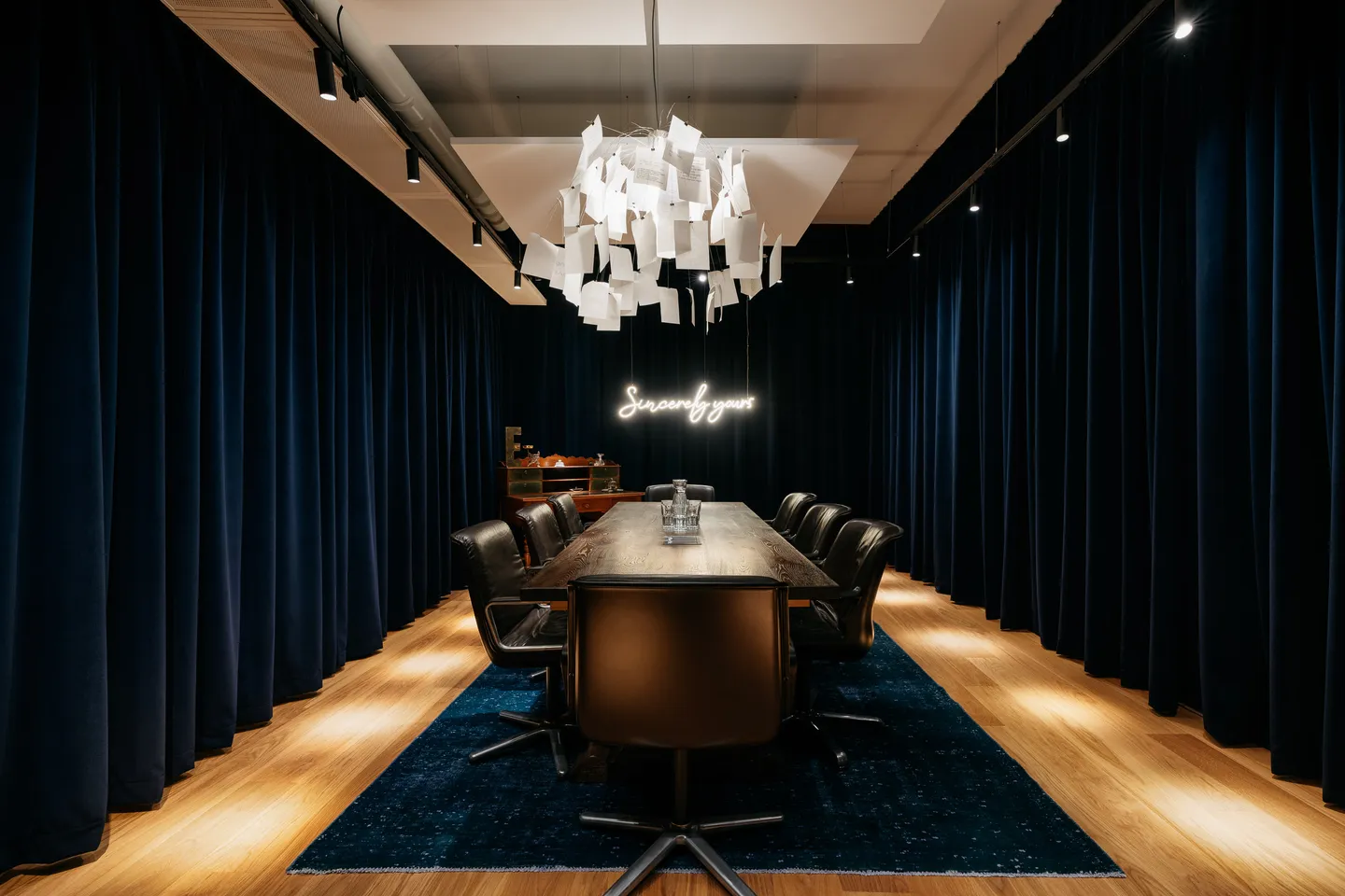 Conference room with a long table and dark curtain
