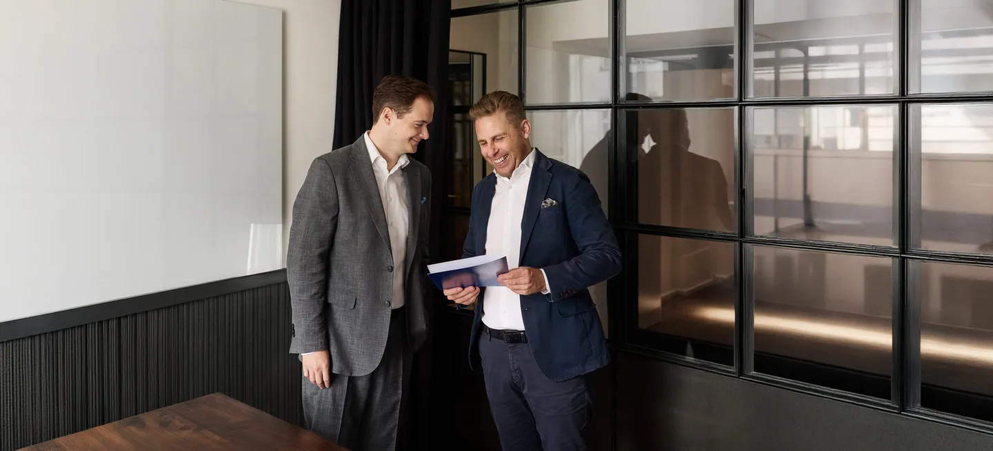 Julian Maly and Wolfgang Hank of fortalent discussing documents
